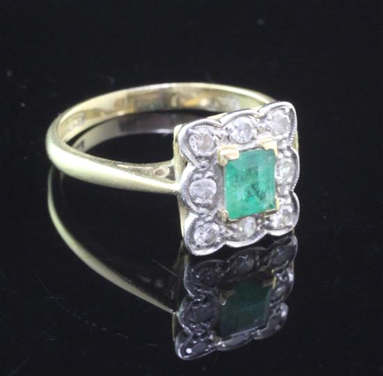 A mid 20th century 18ct gold and platinum, emerald and diamond cluster ring,